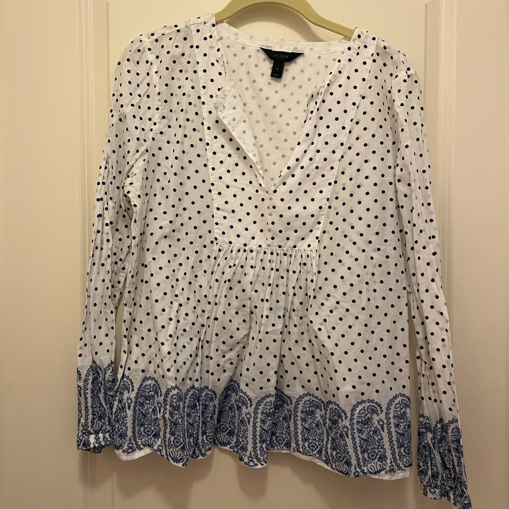 J.crew blouse with polka dots and block print at the bottom.